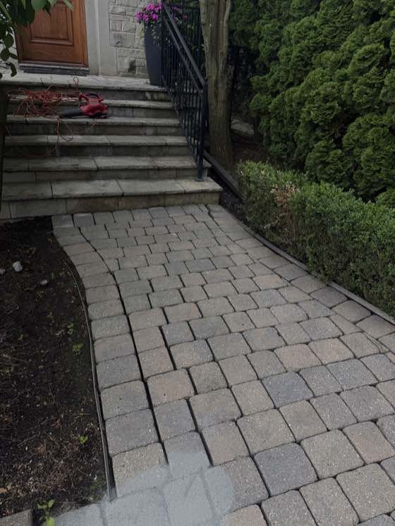 Pressure washing a Toronto paver walkway back to its original colour