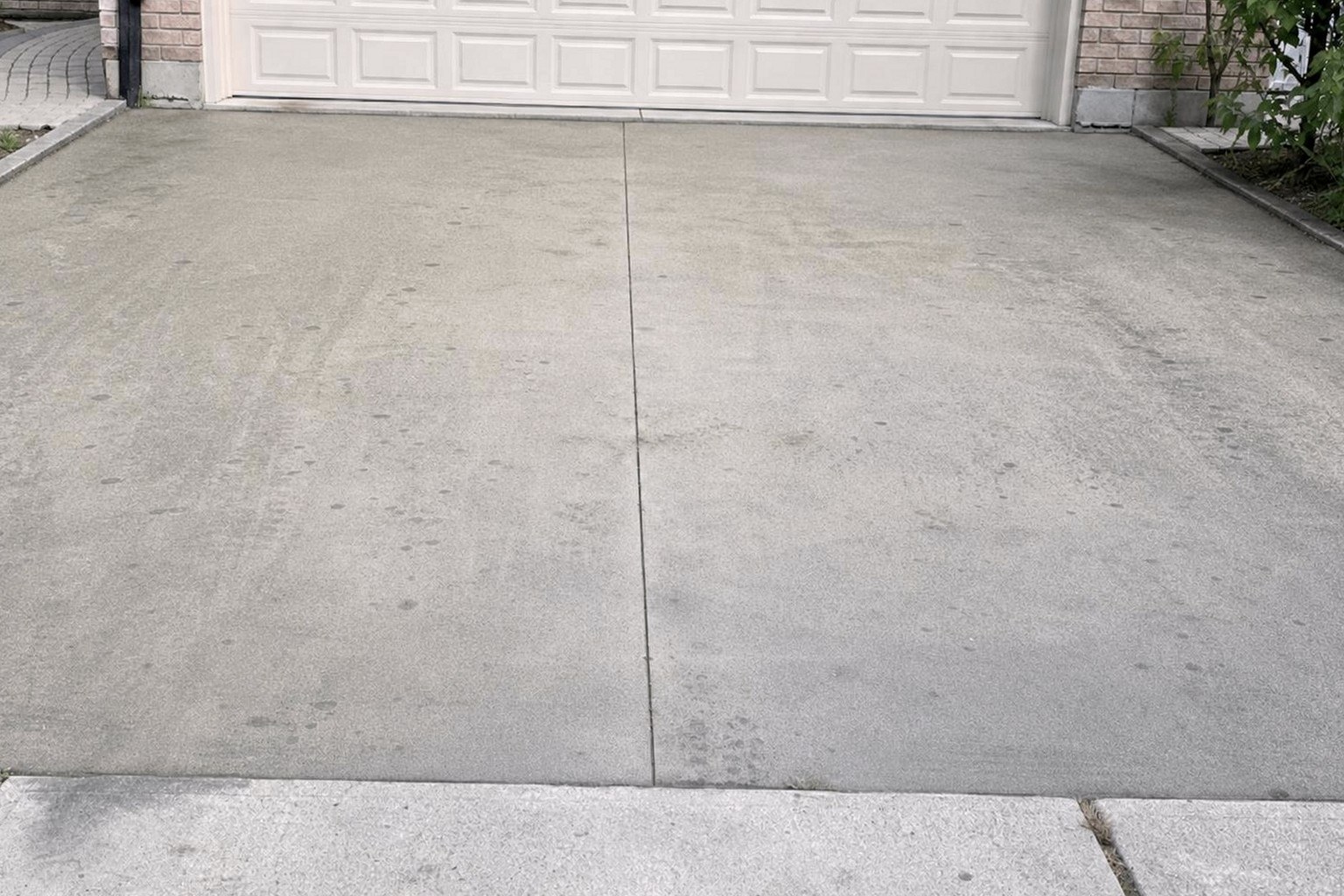 The same concrete pad restored to bright light grey