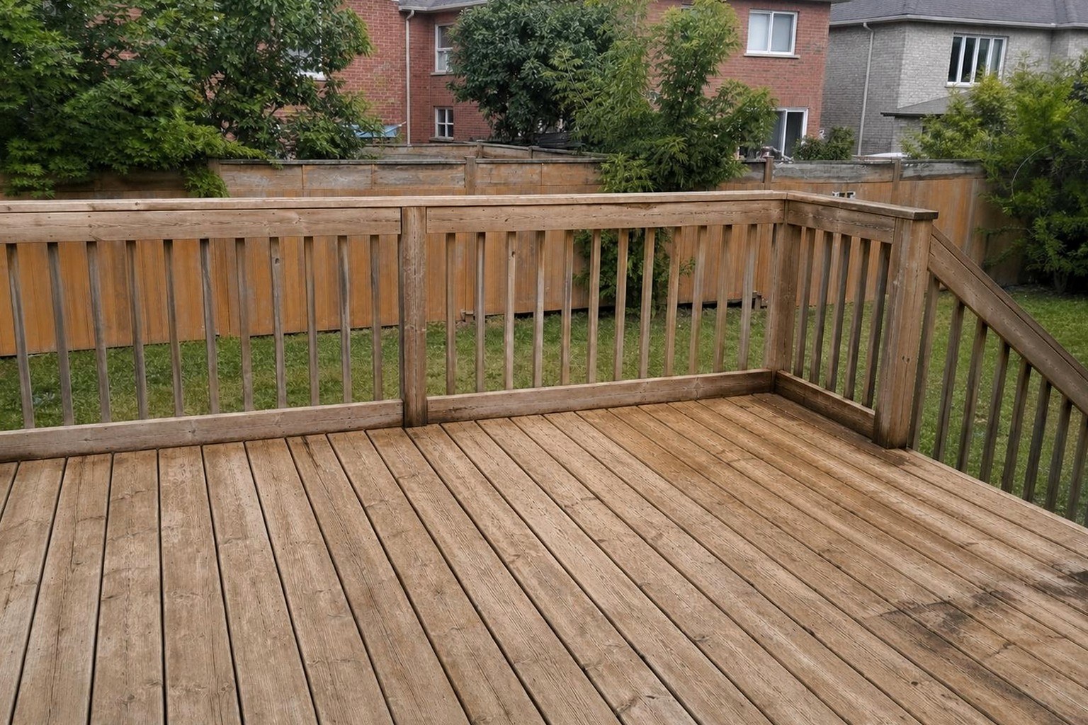 The same deck washed back to its natural wood tone