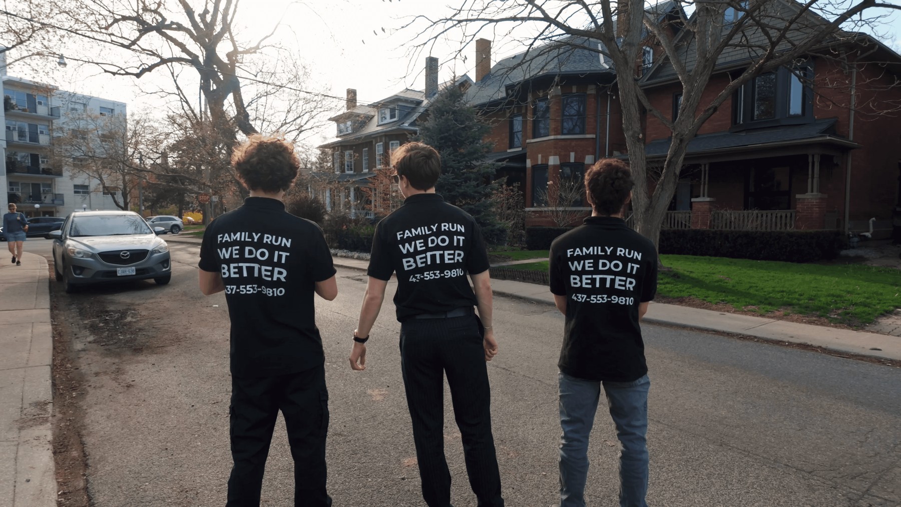 Thirlwell crew in Family Run We Do It Better shirts on a Toronto street