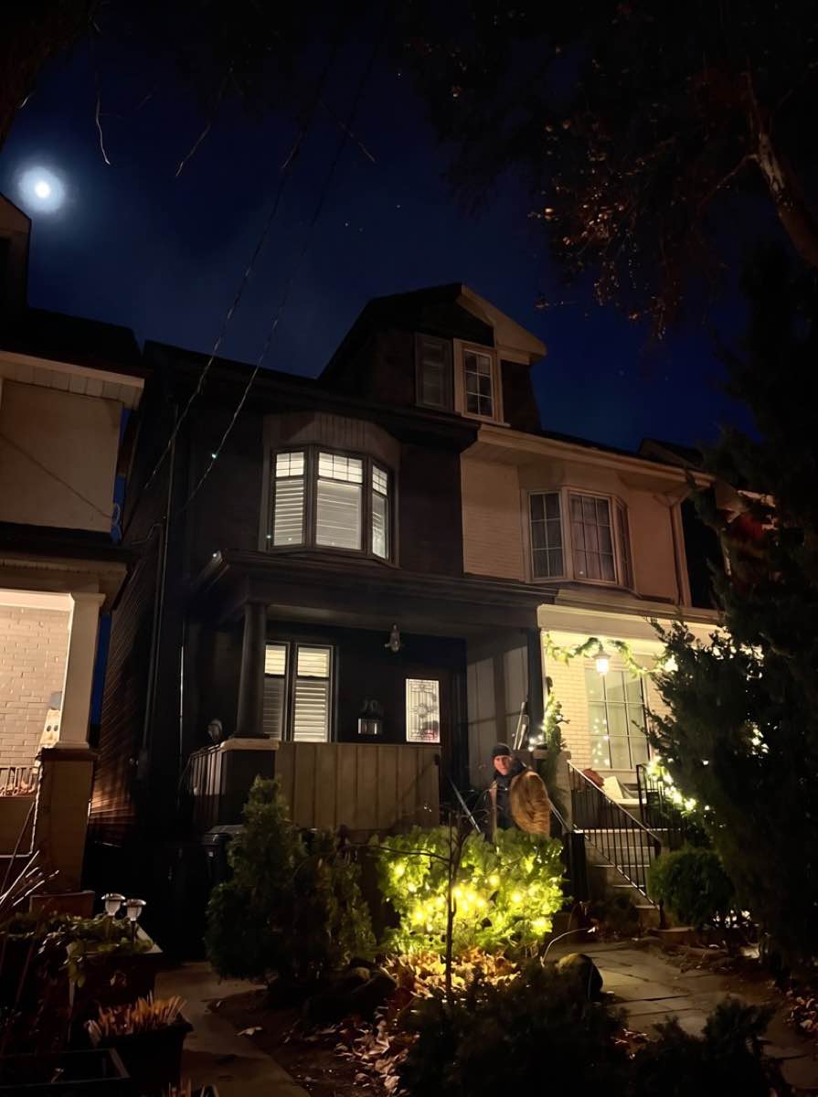 Front of a house at night with no Christmas lights