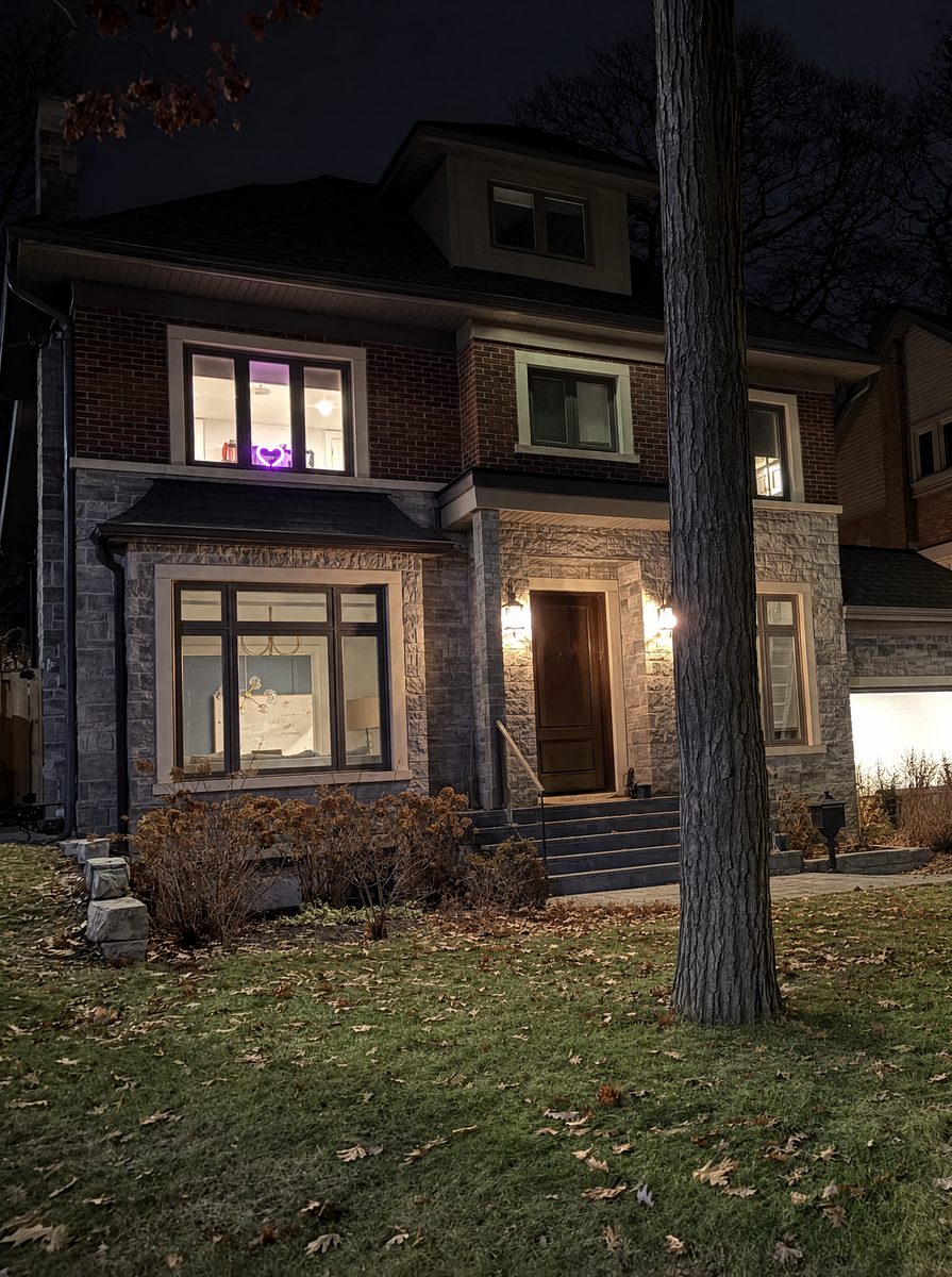 A stone and brick house at night with no lights