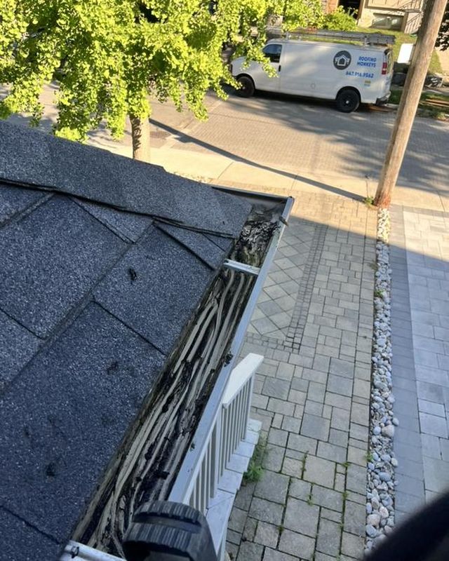 The same gutter run after clearing, empty and clean