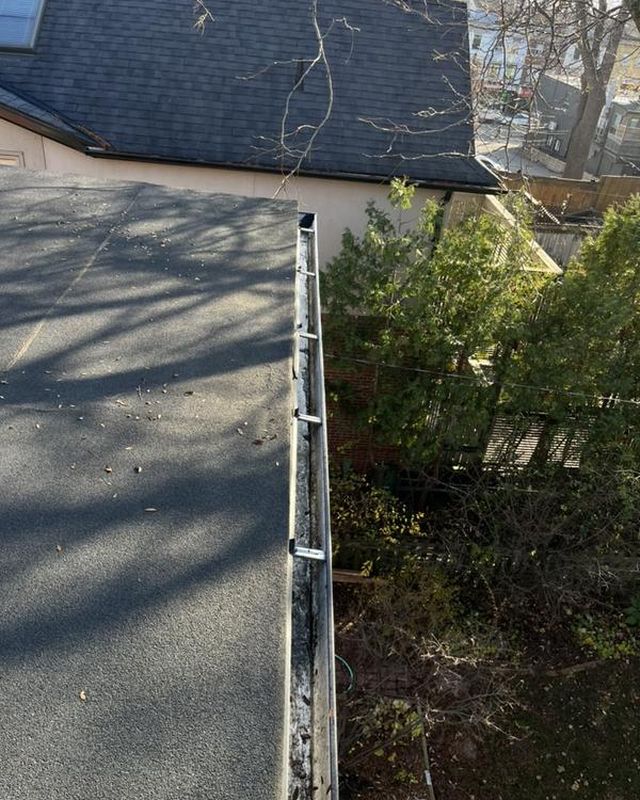 The same gutter after clearing, clean and clear