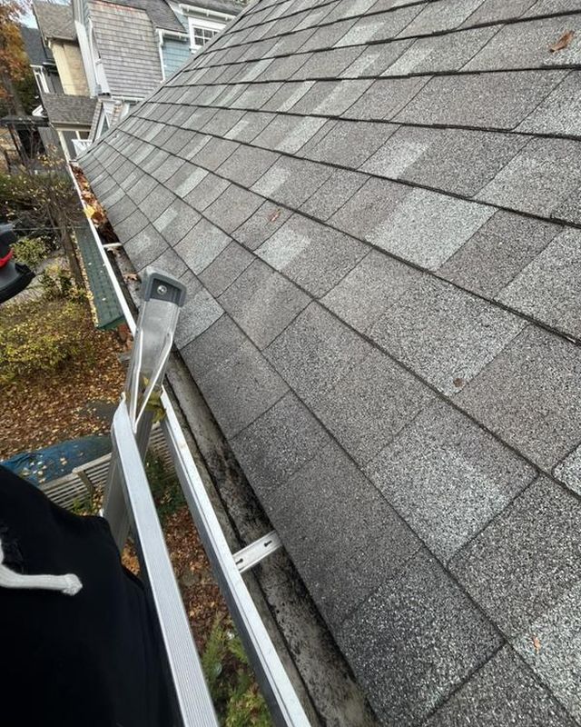 The same gutter after clearing, clean along the roof edge