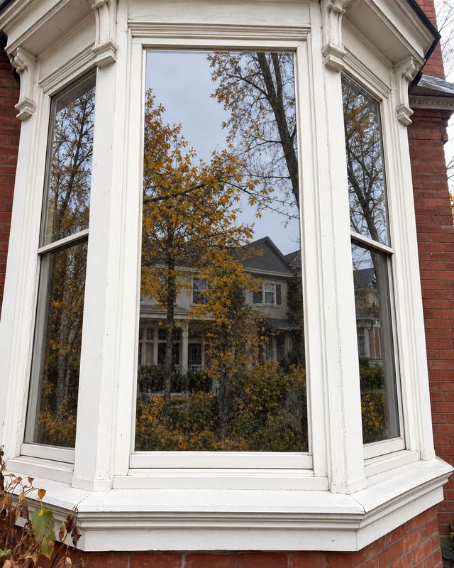 The same bay window after cleaning, glass clear and the white trim and sills wiped